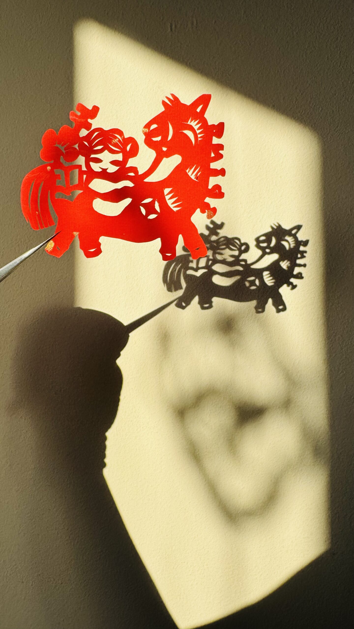 papercutting of a baby riding a pony